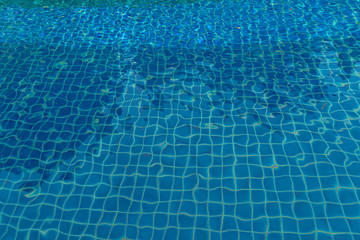 blue water in swimming pool beside the house.