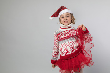 Smiling girl in the winter look on the grey