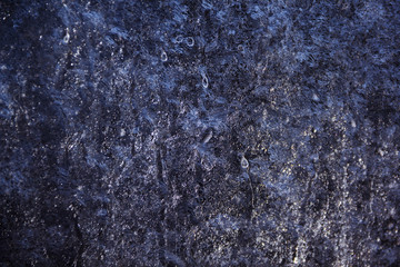 Frozen drops of water on glass, background