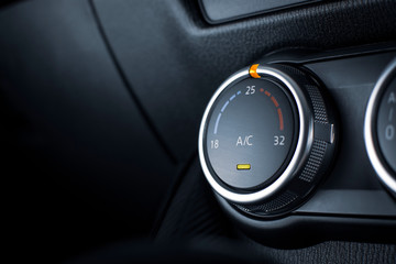 Air conditioner button for temperature climate adjustment in a car.