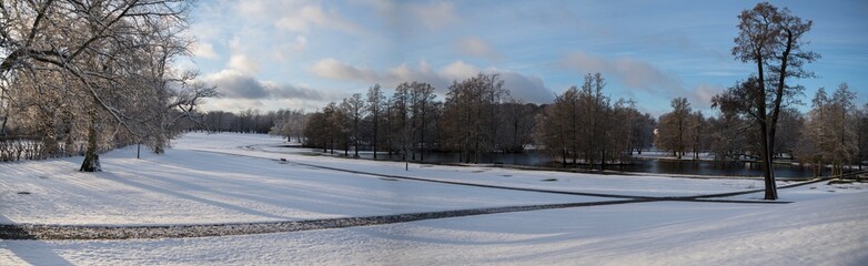 Snowy sunset park view at a pond on the Drottningholm island 
