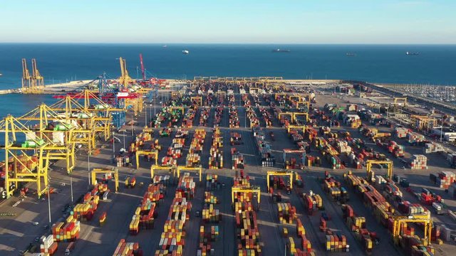 Port of Valencia aerial view sunset time thousands of containers on the quay Spain. Left to right traveling