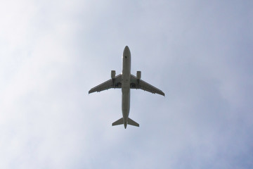 passenger plane against the background of clouds the bottom view