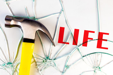 Hammer with broken glass ad word Life. Broken Life concept.