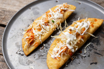 Mexican empanadas with cabbage and red sauce