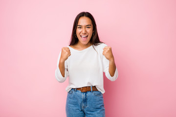 Young mixed race indian woman cheering carefree and excited. Victory concept.