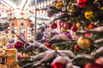2019.01.13, Moscow, Russia. Festive decorative toys on the New Year Tree on background of carousel. 