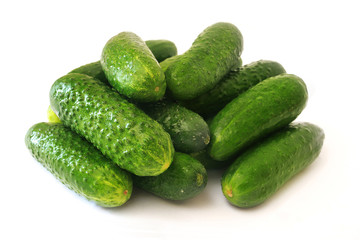 fresh green cucumbers on white background