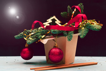 Christmas composition. Wok paper box. Christmas tree and decorations.