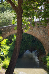 The Darro river and a medieval bridge in Albaicin district of Granada, Spain
