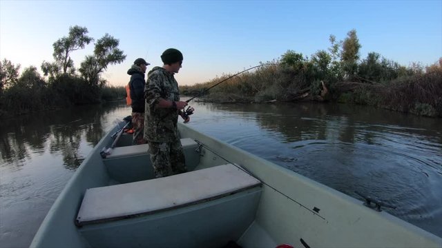 Angler catches the asp fish (Leuciscus aspius) from the boat