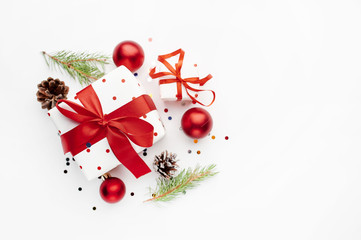Christmas composition on a white background with white gift boxes, with a red ribbon with fir...
