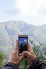 smart phone in man's hand photography landscape