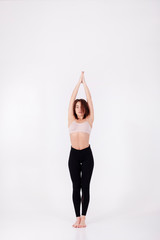 Young beautiful girl performs yoga exercises