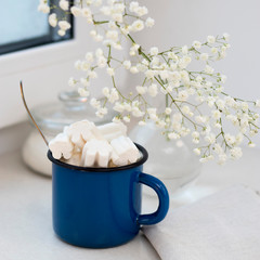 Gypsophila bouquet on the window in a glass vase at dusk.