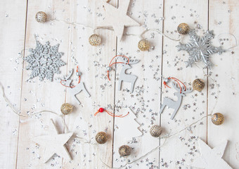 Christmas layout with wooden decorations on a wooden background, covered with silver stars