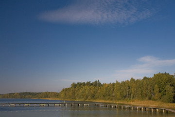  autumn landscape with trees, lake and blue sky in Poland in Europe