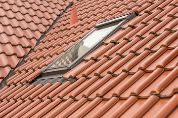 Roof window on a red tiled roof