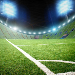 Football stadium and a corner of a field with grass and lights with flashes