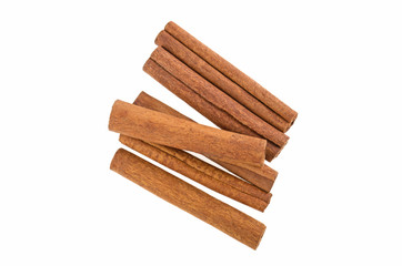 many cinnamon sticks on a white background isolated