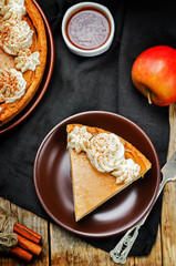 apple cake decorated with whipped cream and cinnamon