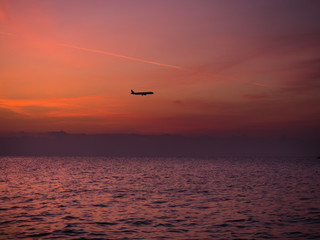 A plane flying over the sea at dawn, sunrise. Larnaca, Cyprus