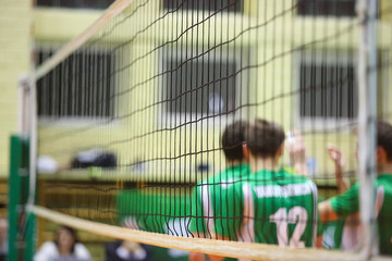 Volleyball players in tne background of volleyball net
