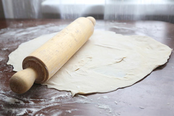 fresh unbaked dough with rolling pin