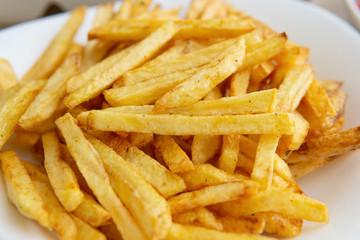 at home, french fries. close-up of finely chopped fried potatoes on white plate