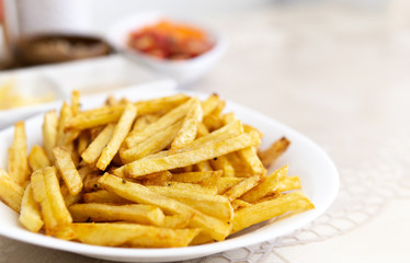 at home, french fries. close-up of finely chopped fried potatoes on white plate