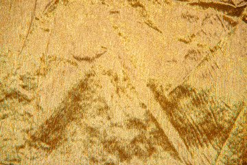 goldener Glitzerstoff mit weichen Falten, weihnachtlicher Hintergrund