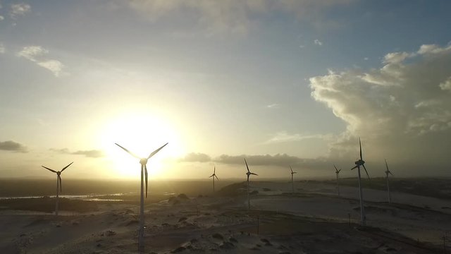 Hawt Wind Turbines at Power Station, Cinematic Aerial View on Golden Hour With Sun in Backlight