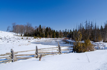 winter scene of frozen river in the country