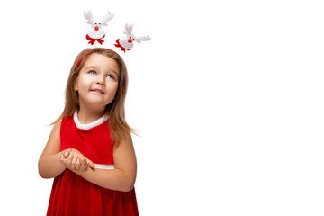 Cute Happy girl Smiles, the child wears a red outfit. Girl wears a Christmas Santa Dress. Beautiful Kid is Laughing and posing in Studio. Little Girl at party. Isolated. White Background .  