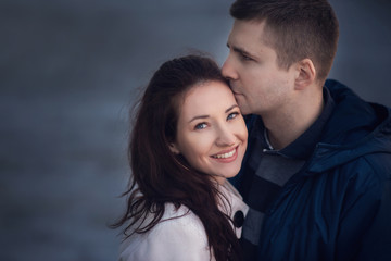 Young couple in love outdoor. They are smiling and looking at each other.
