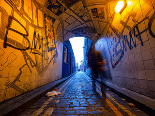 Man walking in an alley of white chapel district
