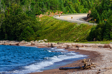 beach with curving road in the distance