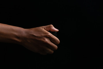 Hand holding burning gas lighters on dark background, Portable device used to create a flame, Close up