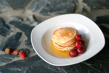 Pancakes with strawberry and syrup. Breakfast concept 