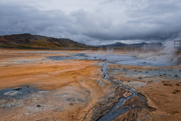 Hverir geothermal area in North Iceland. dy geysers and sulfur field. Orange mountains Iceland.