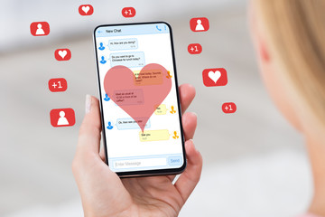 Woman Holding Mobile Phone Donating Money