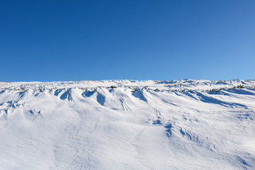 Winter mountain landscape with mountains and blue sky
