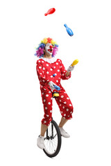 Clown on a unicycle juggling © Ljupco Smokovski