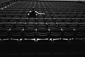 guy sitting in stadium seats