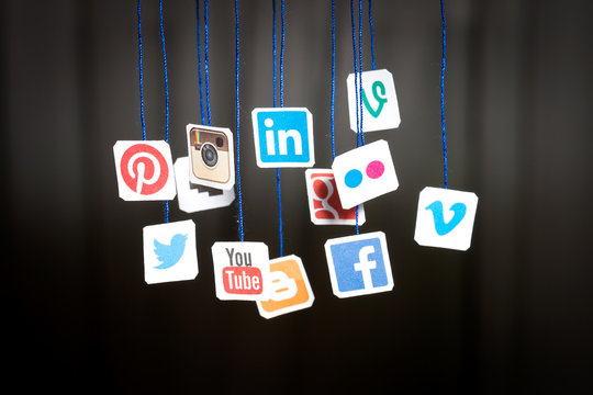 Popular Social Media Website Logos Printed On Paper And Hanging On Strings.