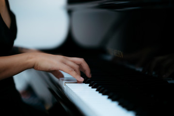 woman hands playing piano