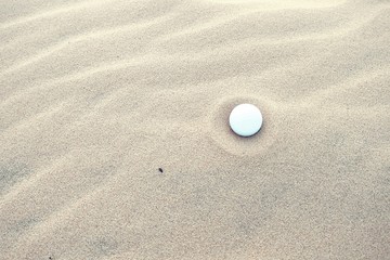 Fototapeta na wymiar Golf ball in sand at bunker