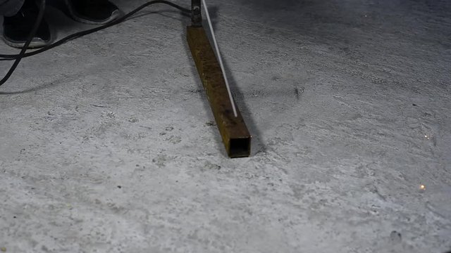 Workers cut, saw and a worker in a hard job