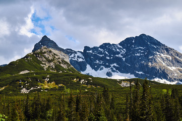 Fototapeta premium Rocky peaks and clouded sky in the Tatra Mountains in Poland..