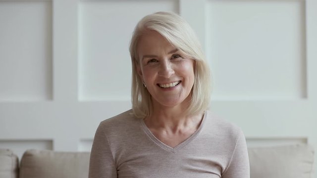 Older lady making video call on skype talking to webcam